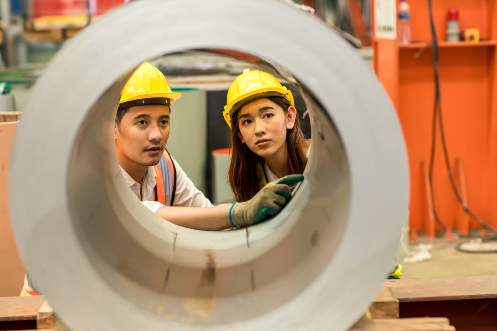 Plant team inspecting a production roll on the factory floor