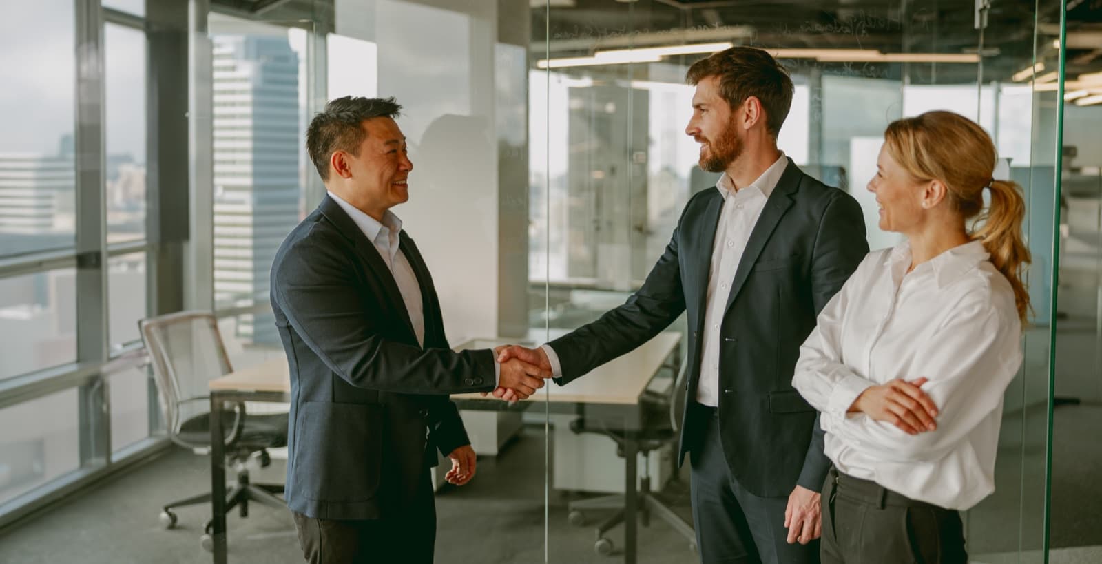 Business partners shaking hands after a deal