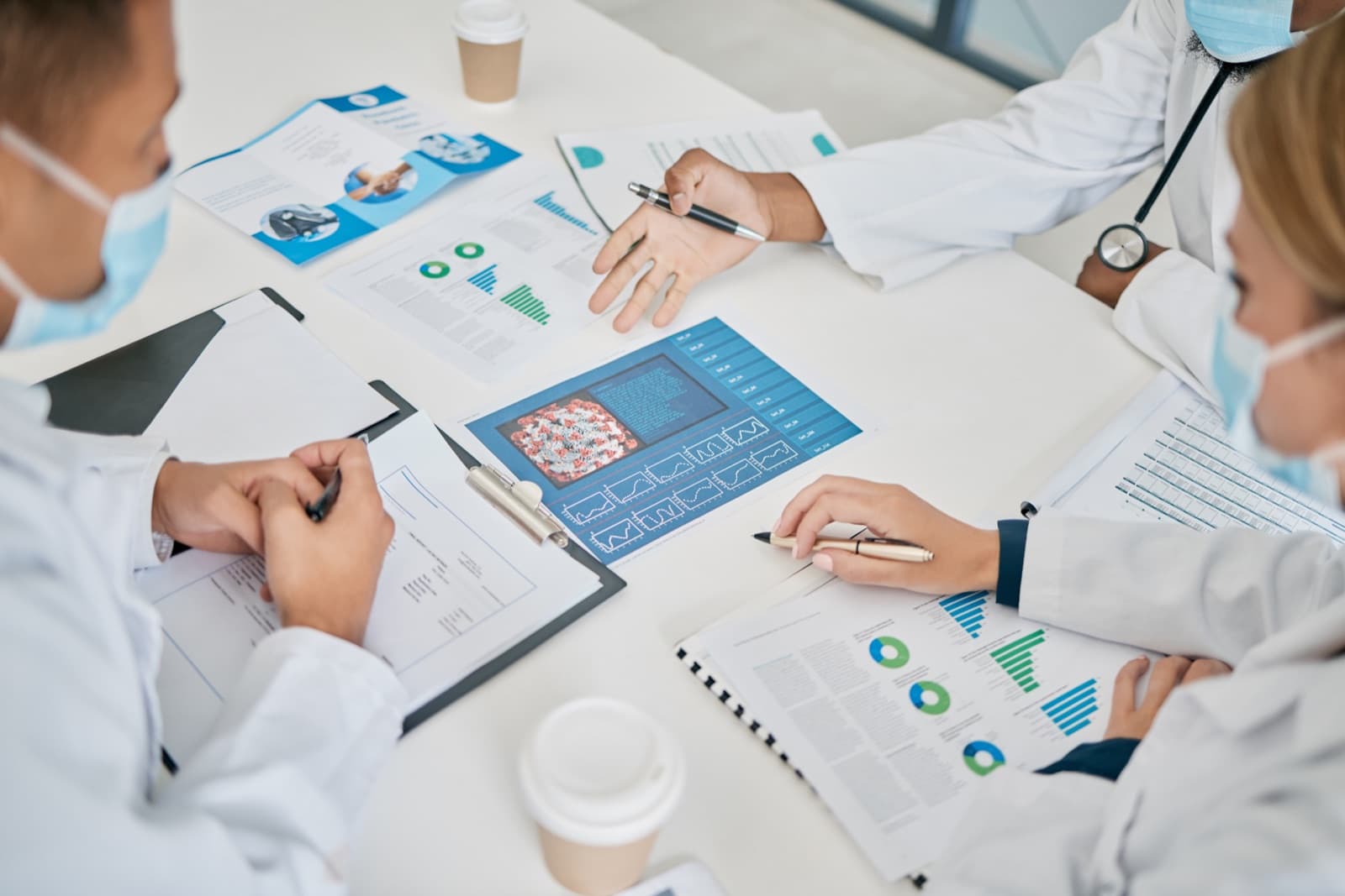 Pharmaceutical team reviewing supply-chain and costing reports