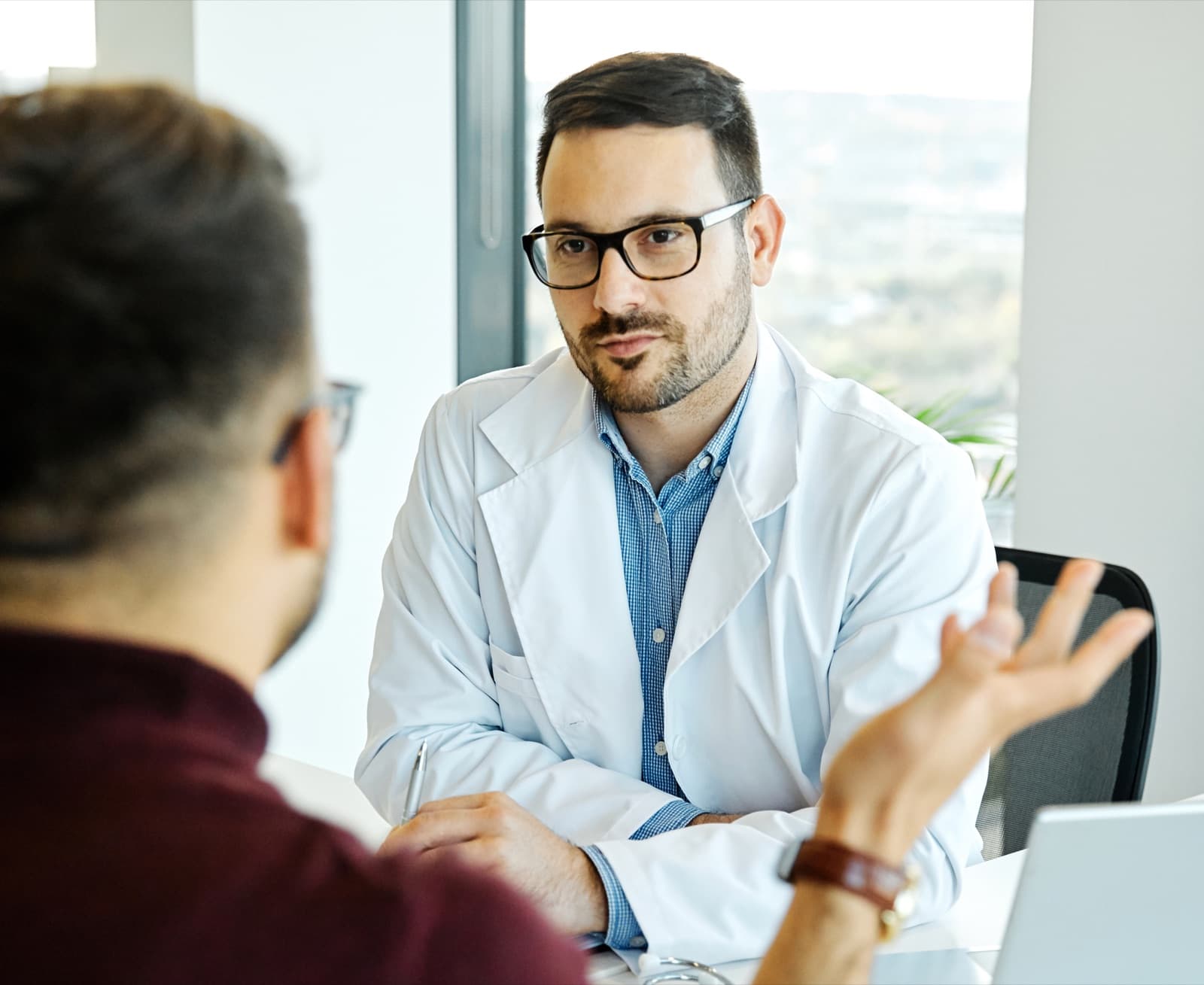 Clinician meeting with a patient in a bright office